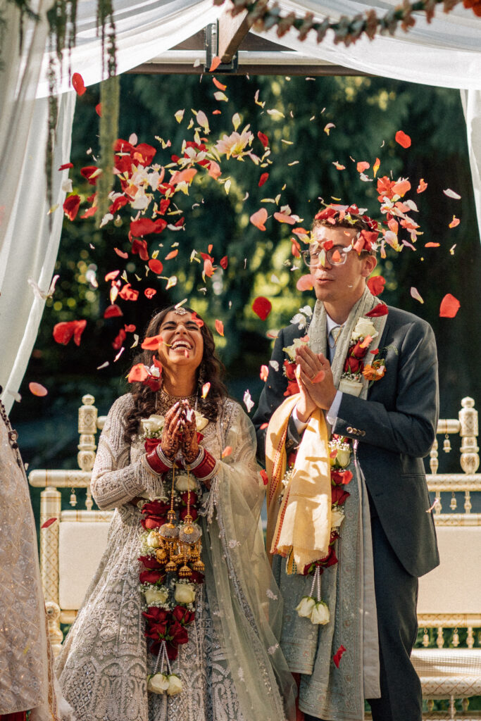 indian ceremony with vibrant flowers being thrown