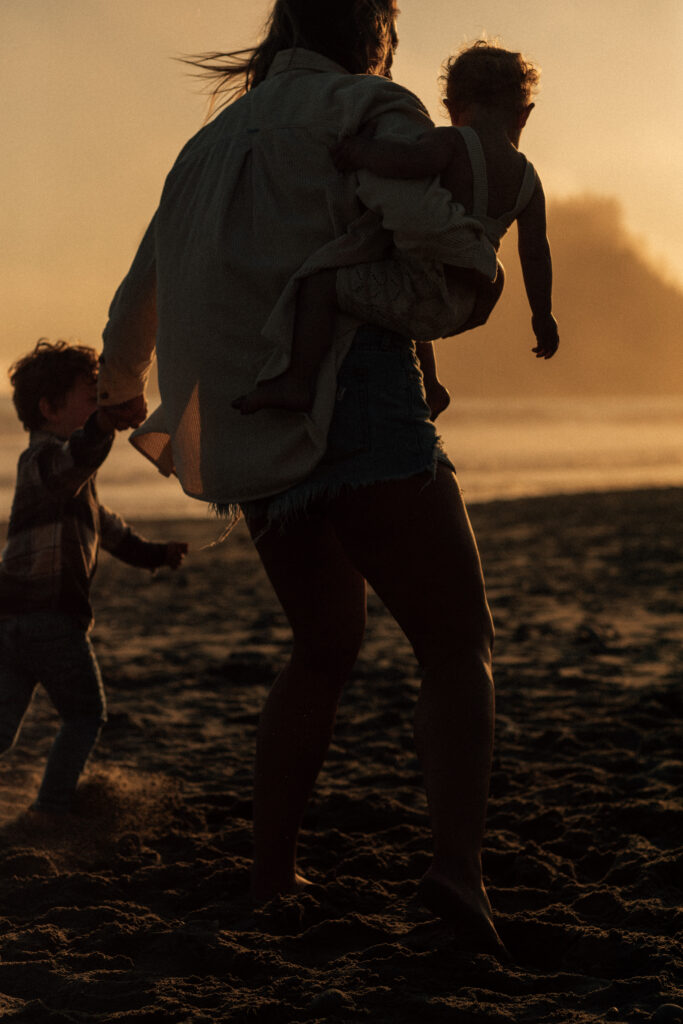 family on beach at sunset