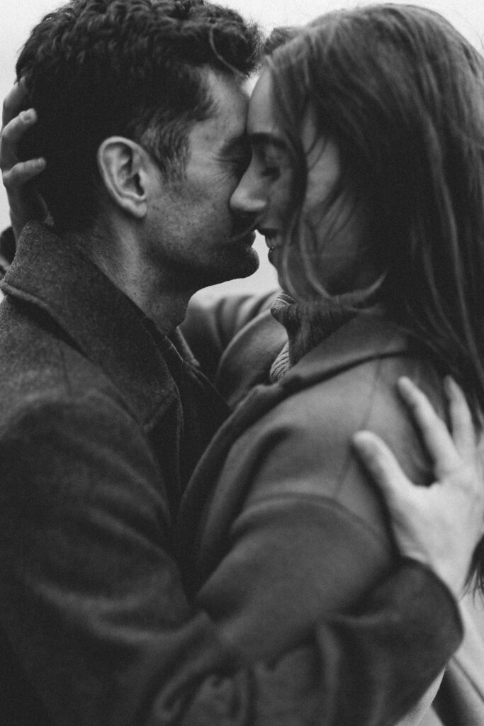 black and white engagement photo of couple embracing