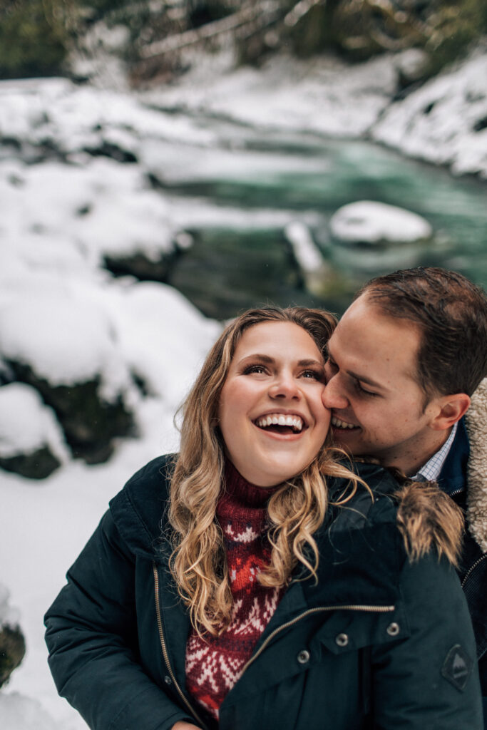 snowy engagement by the river